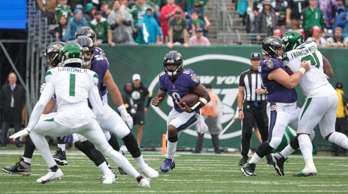 Sep 11, 2022; East Rutherford, New Jersey, USA; Baltimore Ravens quarterback Lamar Jackson (8) carries the ball as New York Jets cornerback Sauce Gardner (1) defends during the first half at MetLife Stadium.